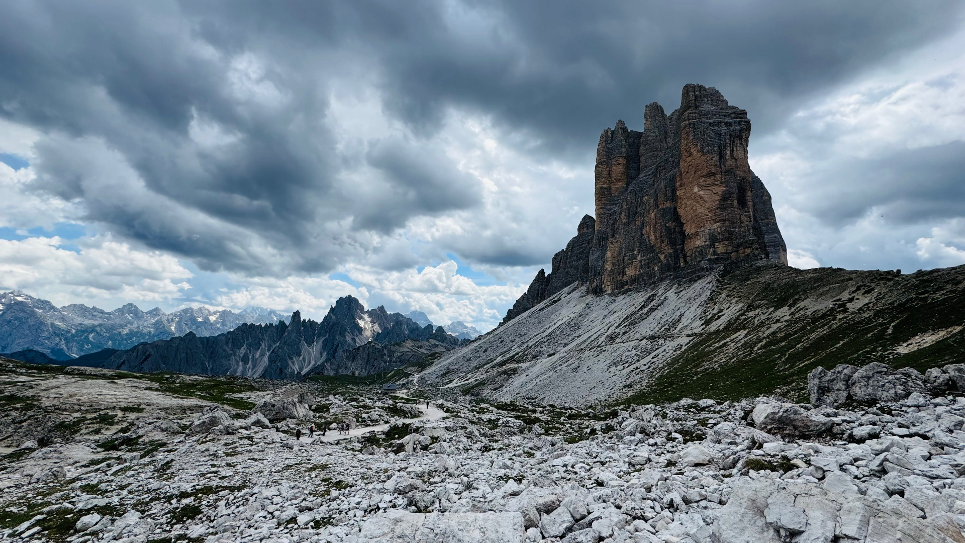 Tre Cime di Lavaredo three peaks under storm clouds — hiking guide to the Italian Dolomites